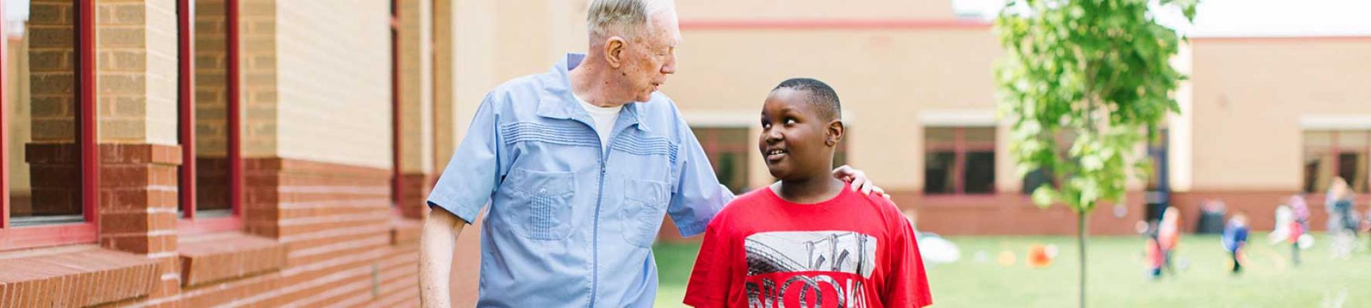 Adult and child talking at school